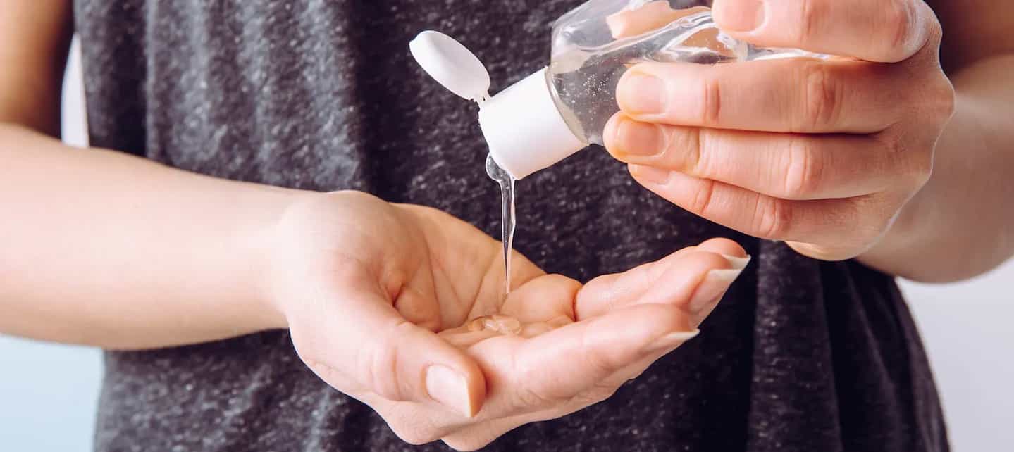 En hånd som heller antibac fra en flaske